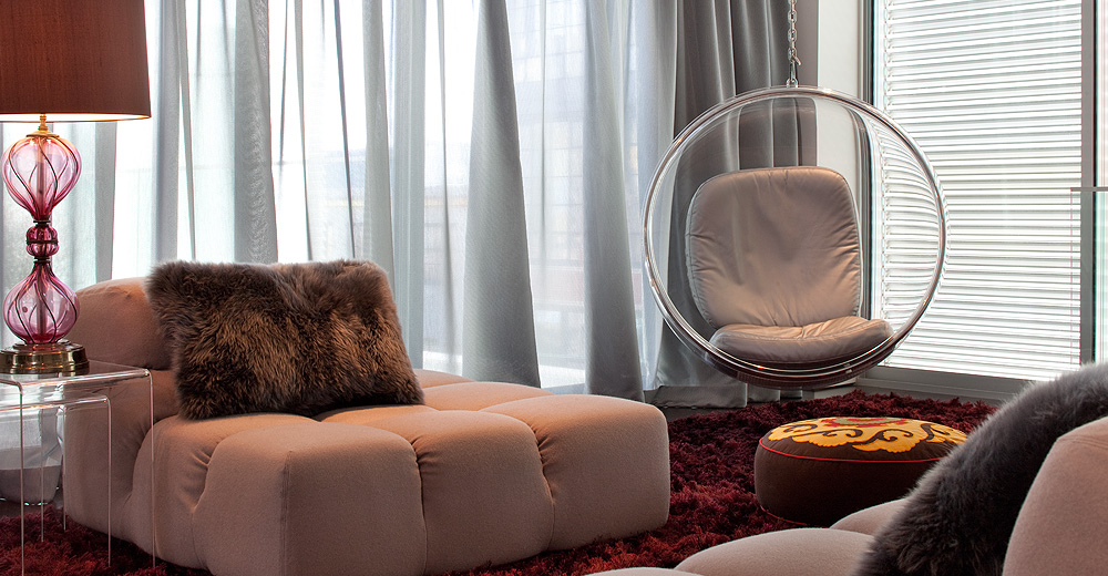 San Francisco modern living room has B&B Italia sofas, crimson shag rug, and a hanging Aarnio bubble chair.