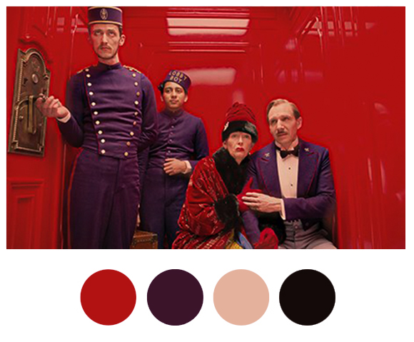 Scene in the elevator at "The Grand Budapest Hotel" featuring 4 color palettes in circles below - red, purple, pink and black