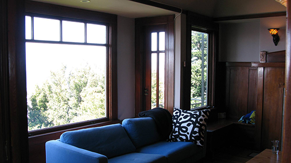 Dark blue fabric and dark wood make this Russian Hill bay window look dreary, while the view is ignored