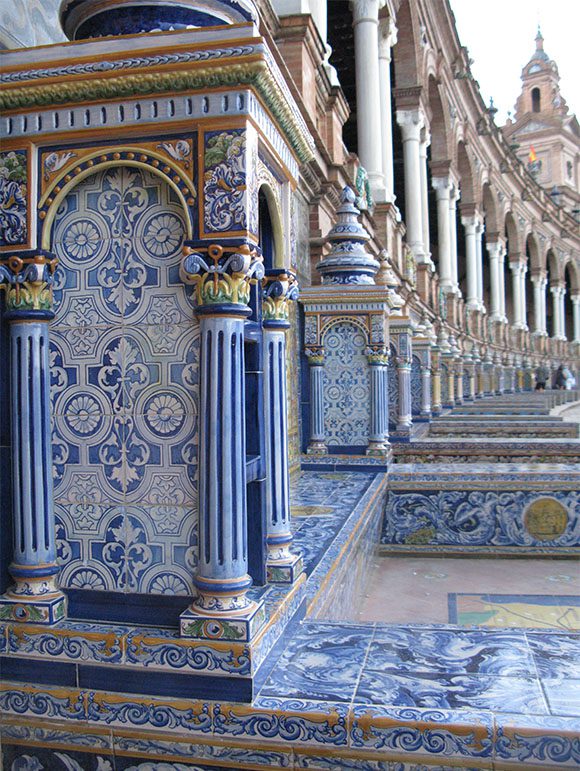 A row of repeating classic arches and columns with blue and gold detailing