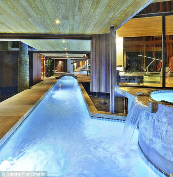 Ipe wood is among the multiple wood species used as decking, to create a bridge, and composing the walls and ceiling surrounding this amazing indoor residential lazy river.