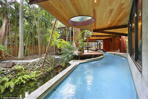 An indoor lazy river runs through this architect's home, featuring lush garden views.