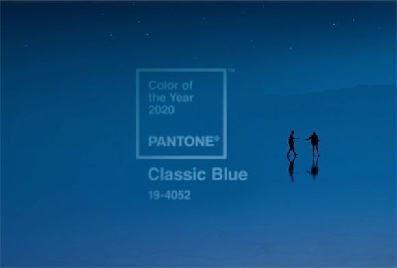 Image of the 2020 Color of the Year by Pantone: Classic Blue #19-4052, with outlines of two people standing in the distance, their reflections showing in water below.