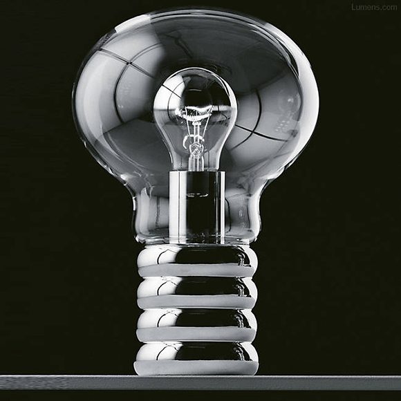 The bulb-inside-a-bulb design -- of a hand-blown crystal glass shade and polished chromium base -- is matched inside by a top-chromated incandescent bulb. The entire table lamp is shown against a solid black background.