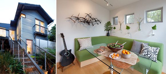 Two side-by-side images. On the left, the grey wooden exterior of a San Francisco condo of only 598 square feet, with steps leading up to an orange door. On the right, the interior showing a custom built lime green banquette and custom glass table, with wall vases holding small greenery and a metal wall plaque of flying birds. Three small clerestory windows show a view from above the sofa, while a guitar sits next to the banquette.