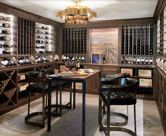 A grand tasting room with counter-height leather chairs and a table in the center, surrounded by illuminated wine racks.