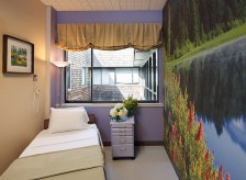 Redesign of Marin chemotherapy treatment room includes a nature photomural, soothing color palette, and soft window treatments which help alleviate patient's anxiety and create calm