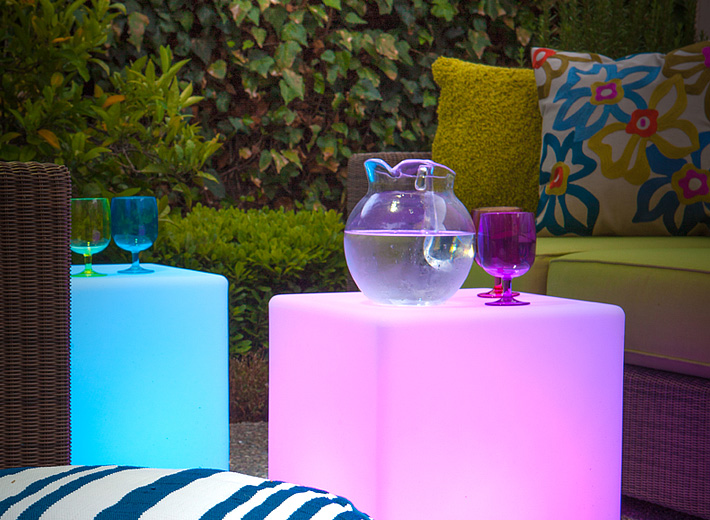 Outdoor LED light cubes serve as both outdoor side tables and additional seating.