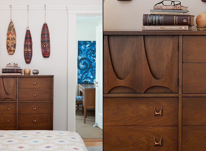 Vintage Broyhill Brasilia dresser and masks hanging as wall decor give this mid-century modern bedroom a whimsical touch.