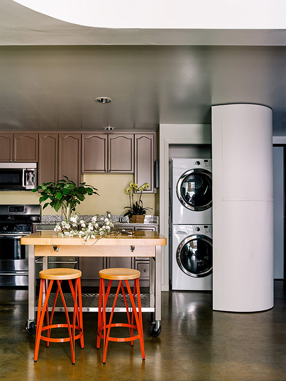 San Francisco loft kitchen by San Francisco designer Kimball Starr showcases a clever design solution to conceal the stackable washer dryer. 