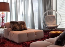 Modern bachelor pad living room has contemporary B&B Italia furniture & Eero Aarnio bubble swing chair.