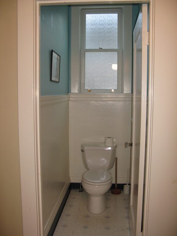 Before image of an outdated powder room