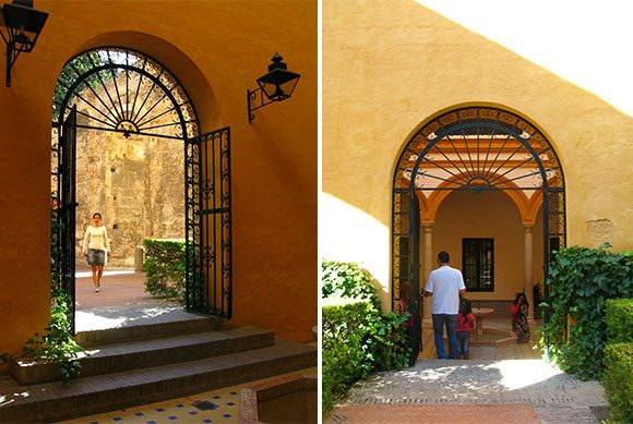 Two photos of the same archway, one from each side. The exterior wall is painted a brick color, and the archway is black metal. The inside wall is painted an ochre-yellow, with light dancing on the steps in each image.