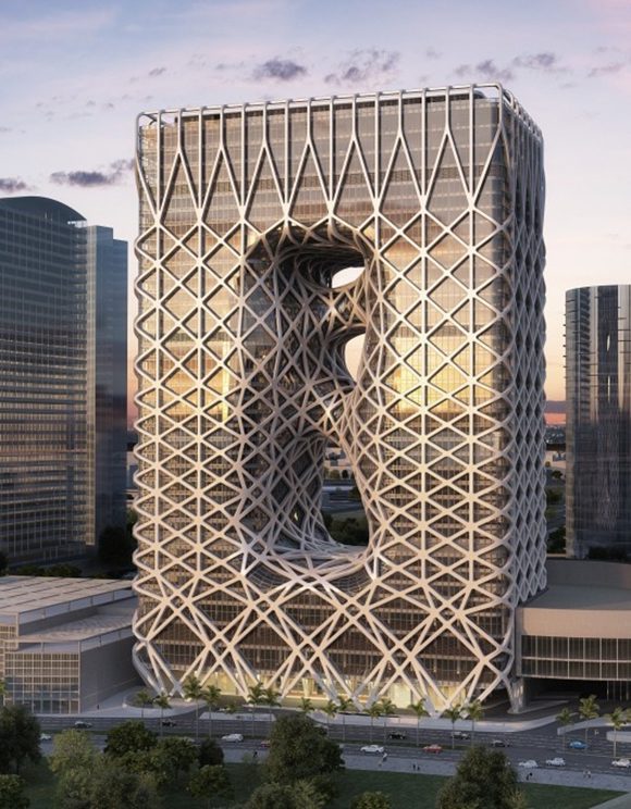 Image of a square hotel in Macau built with a white exoskeleton, pierced three times in the center to create walkways enveloped in the same exoskeleton material. A modern city and streets surround the hotel.