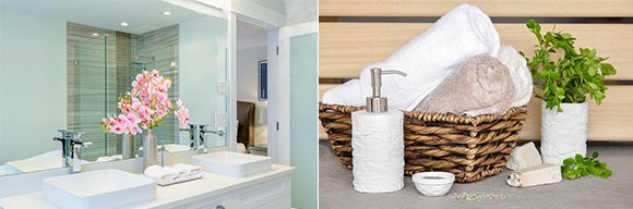 Two images side-by-side. On the left, a light green and white bathroom with double sinks, flowers in a vase, and a tray of hand-rolled towels on the counter. On the right, a basket of hand-rolled towels, with a lotion dispenser and white vase of fresh greens on a grey counter.