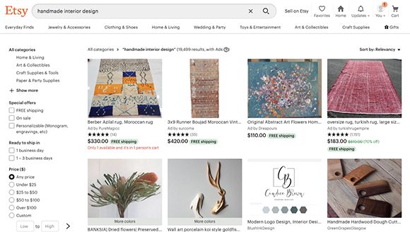 Screen capture of the front page of website Etsy, showing search results for "handmade interior design" with multiple items such as rugs, artwork, wooden sculptures, floral designs, and more.