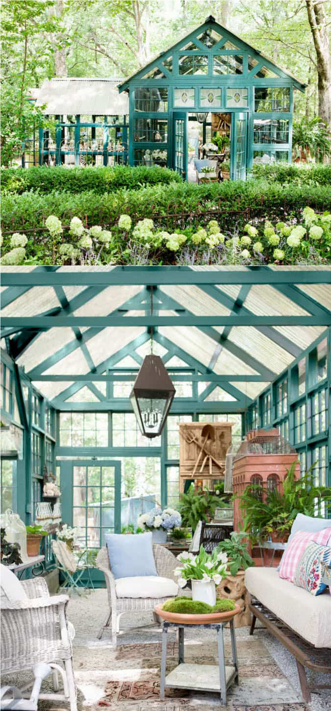 Two images, one on top of the other, show a green painted wooden greenhouse, surrounded by hedges, trees and plants. In the bottom image, we see a hanging lantern above a wicker seating group, and a small potting table with white lilly potted plant. The entire space including roof is glass, held by green painted wood in triangular and square shapes.