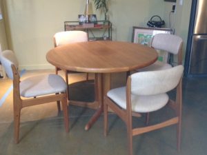 BEFORE: A Scandinavian style wood dining table and chairs set in a plain white fabric.