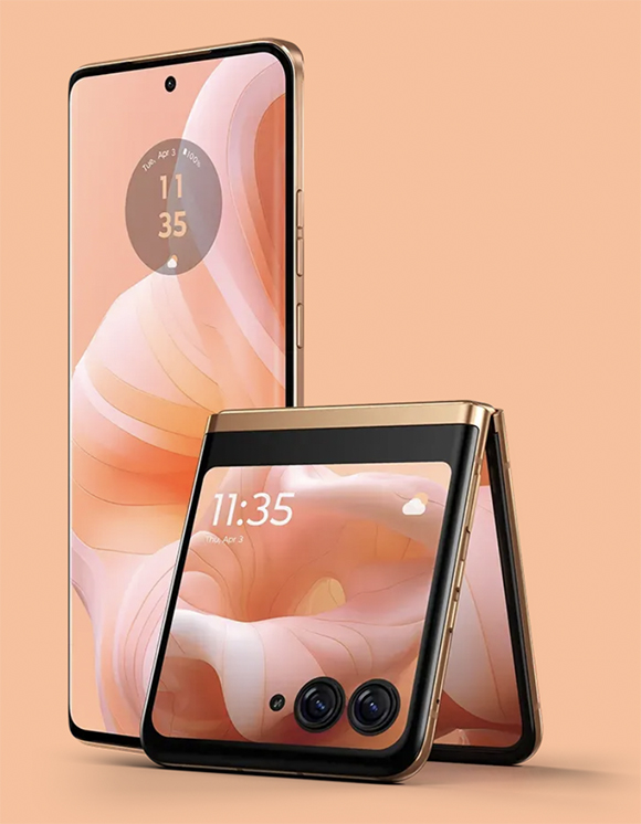 On a light peach background stands a gold and black phone with peach and white and pink colorful striped shapes on the screen and 11:35 showing as the time. Next to it is another of the same phone, folded in half and standing upright, showing the camera lenses on the back which are now on the front as it stands folded. More of the gold edge is visible on the folded phone.
