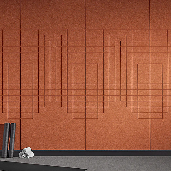 A set of connected panels in an earthy mud/brick color but more orangey with a series of connected geometric lines running horizontally and vertically, connecting in the center and creating boxes and rectilinear shapes. A pile of rolled towels sits on the grey carpeting in front on the floor.
