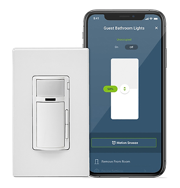 A Leviton Decora white plastic light switch plate with a motion sensor at the top, a large button below and two smaller up and down buttons to the right side. Next to the switch plate is a cell phone showing the app allowing you to control the lighting, with a blue background and a white switch in the center, labeled Guest Bathroom Lights 50%. In small letters near the top is Unoccupied On/Off, and at the bottom Motion Snooze, and Remove From Room.